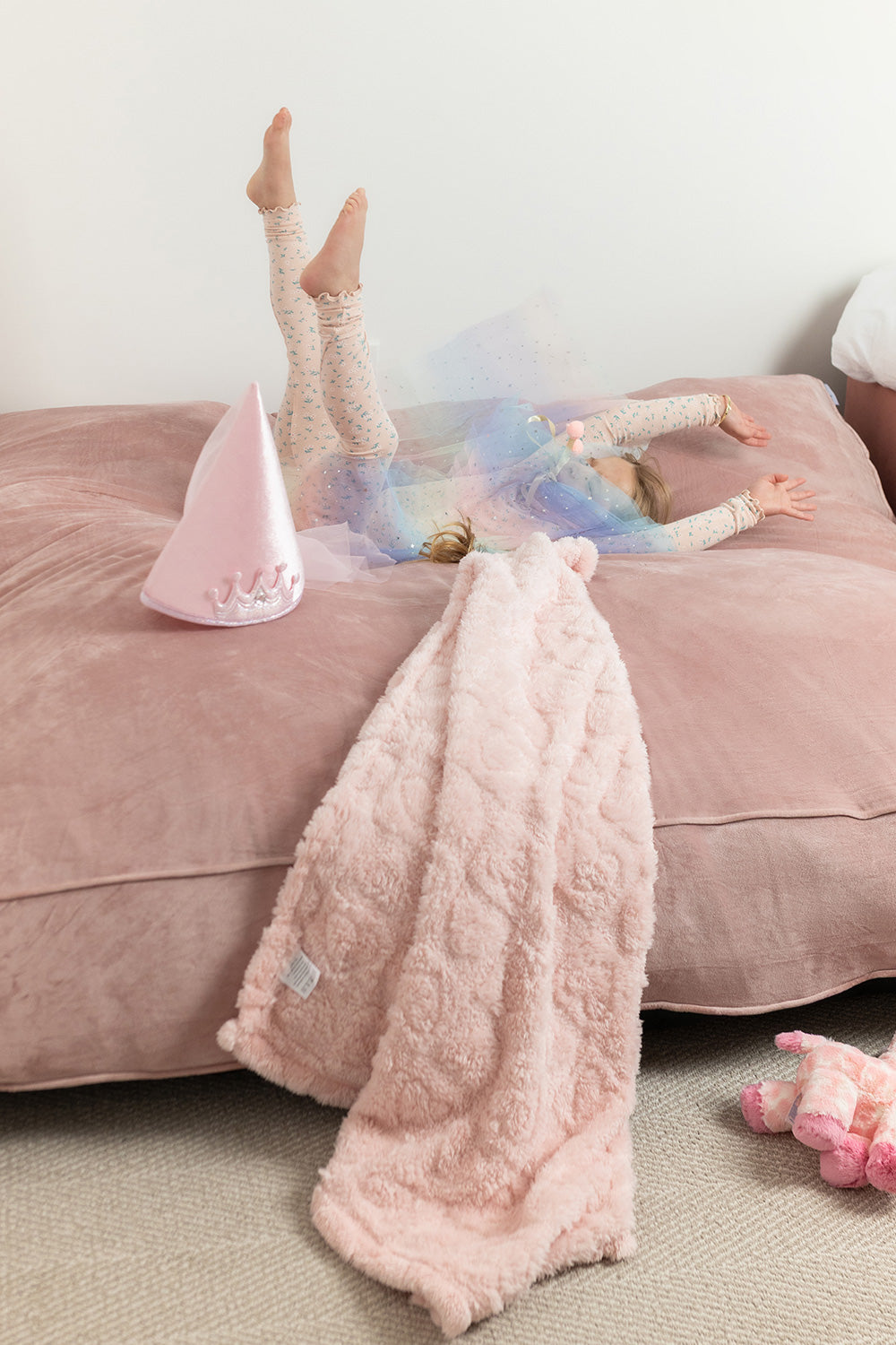 child landing on blush crash pad