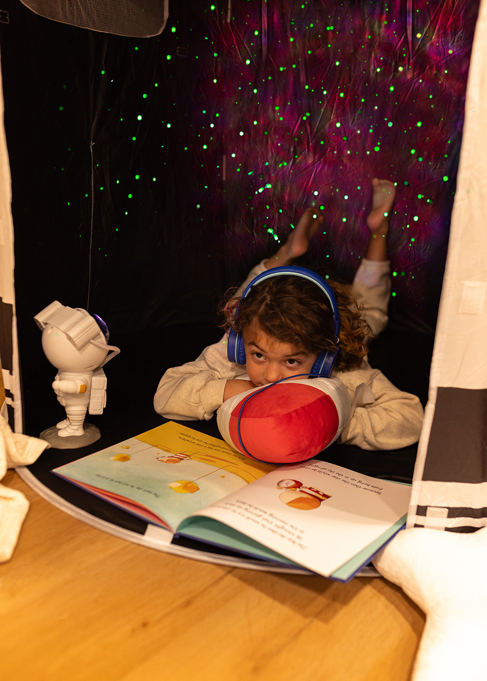 boy reading in space tent