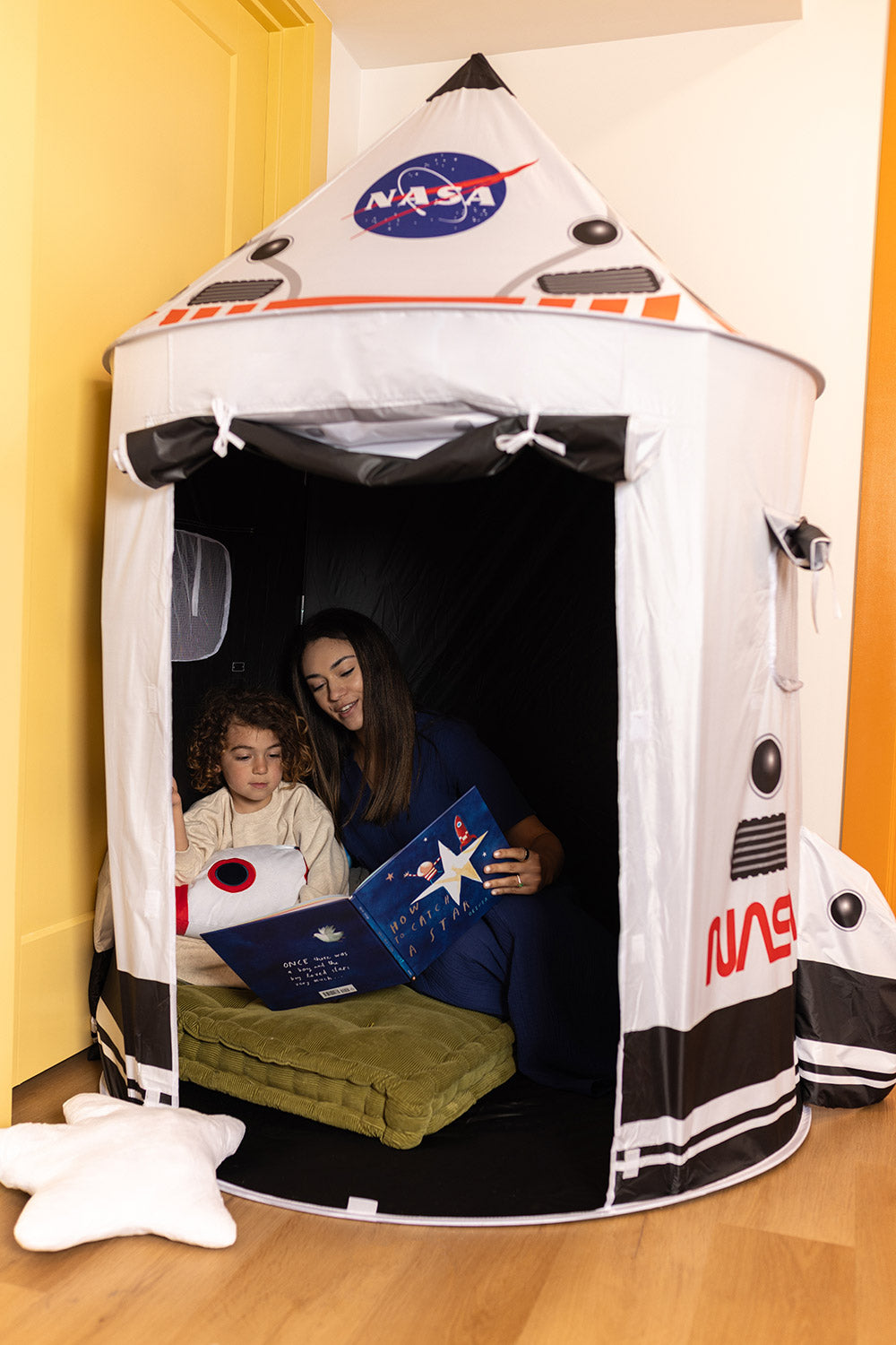 mother & child reading in space tent