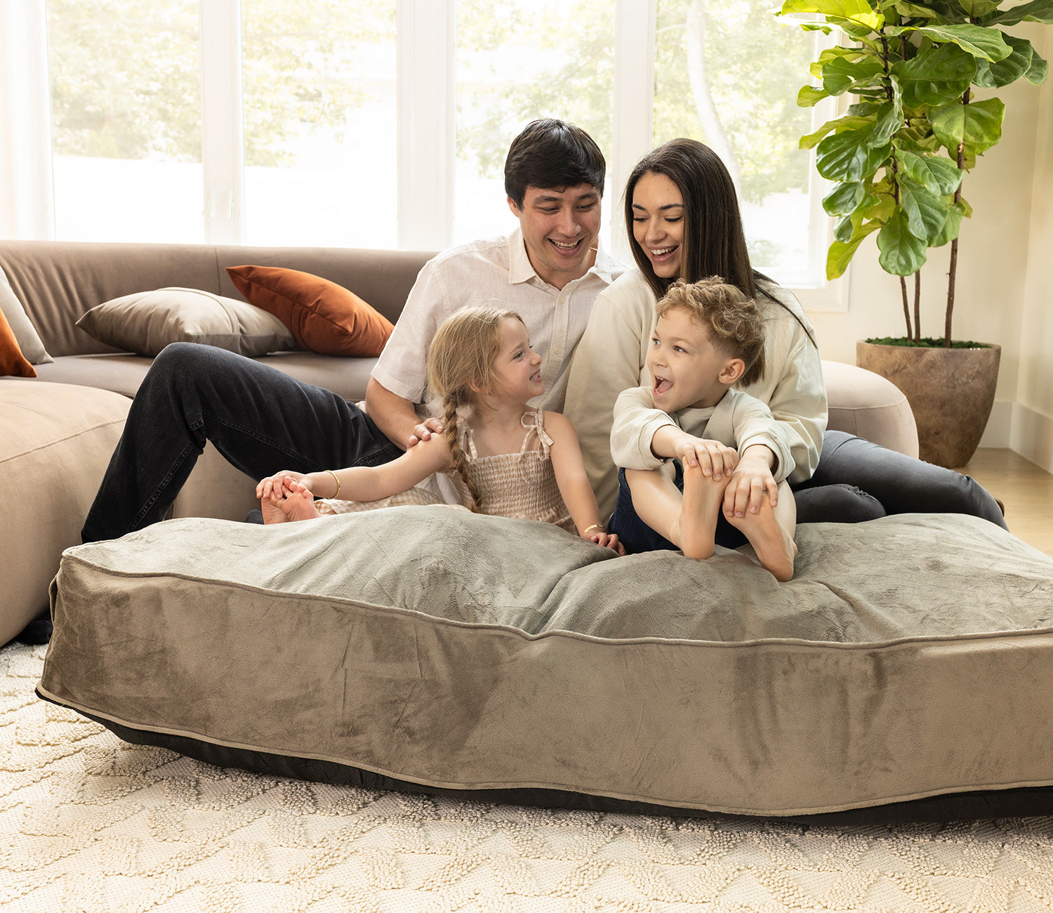 family relaxing on a crash pad