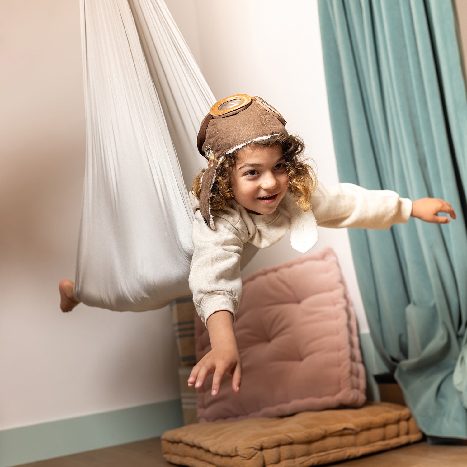 boy flying in sensory swing