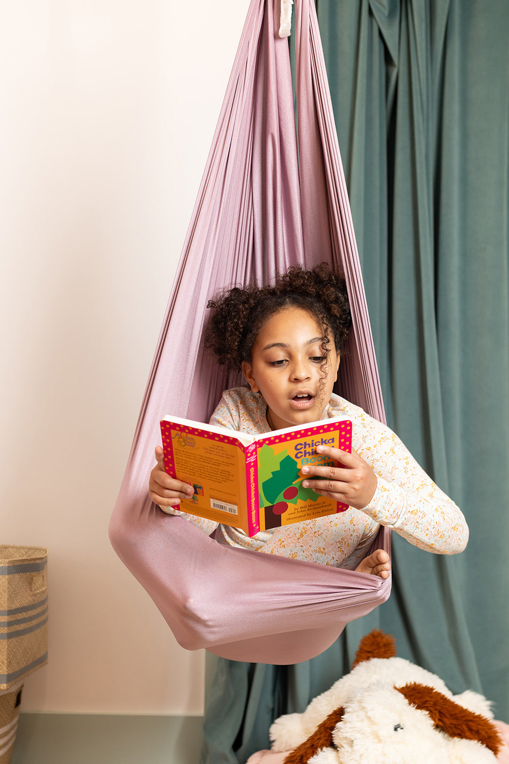 child reading in a sensory swing