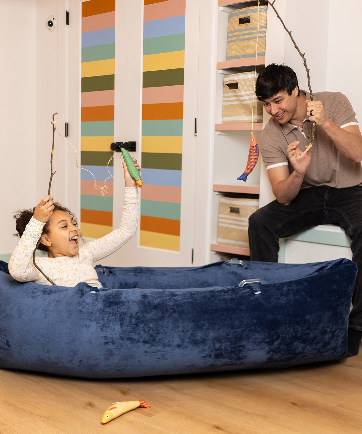 Girl & father play-fishing in sensory canoe