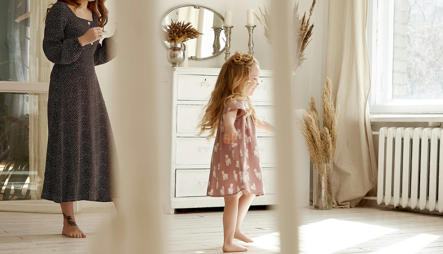 girl dancing in room with her mother
