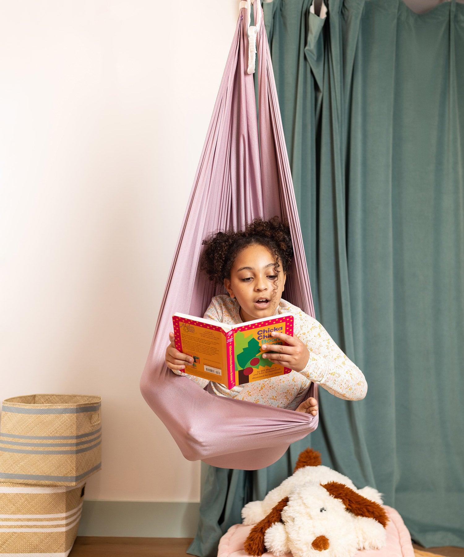 Girl reading while in sensory swing