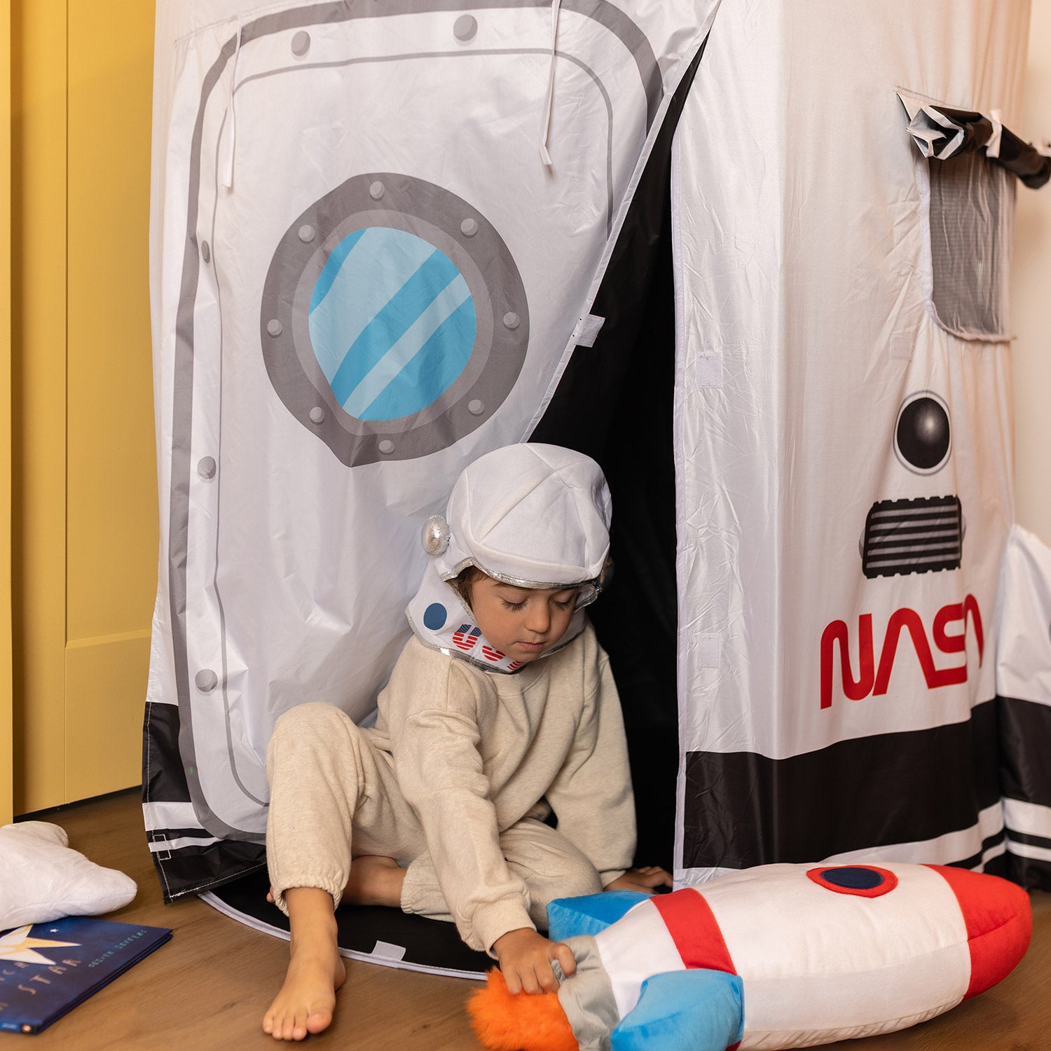 boy playing in space tent